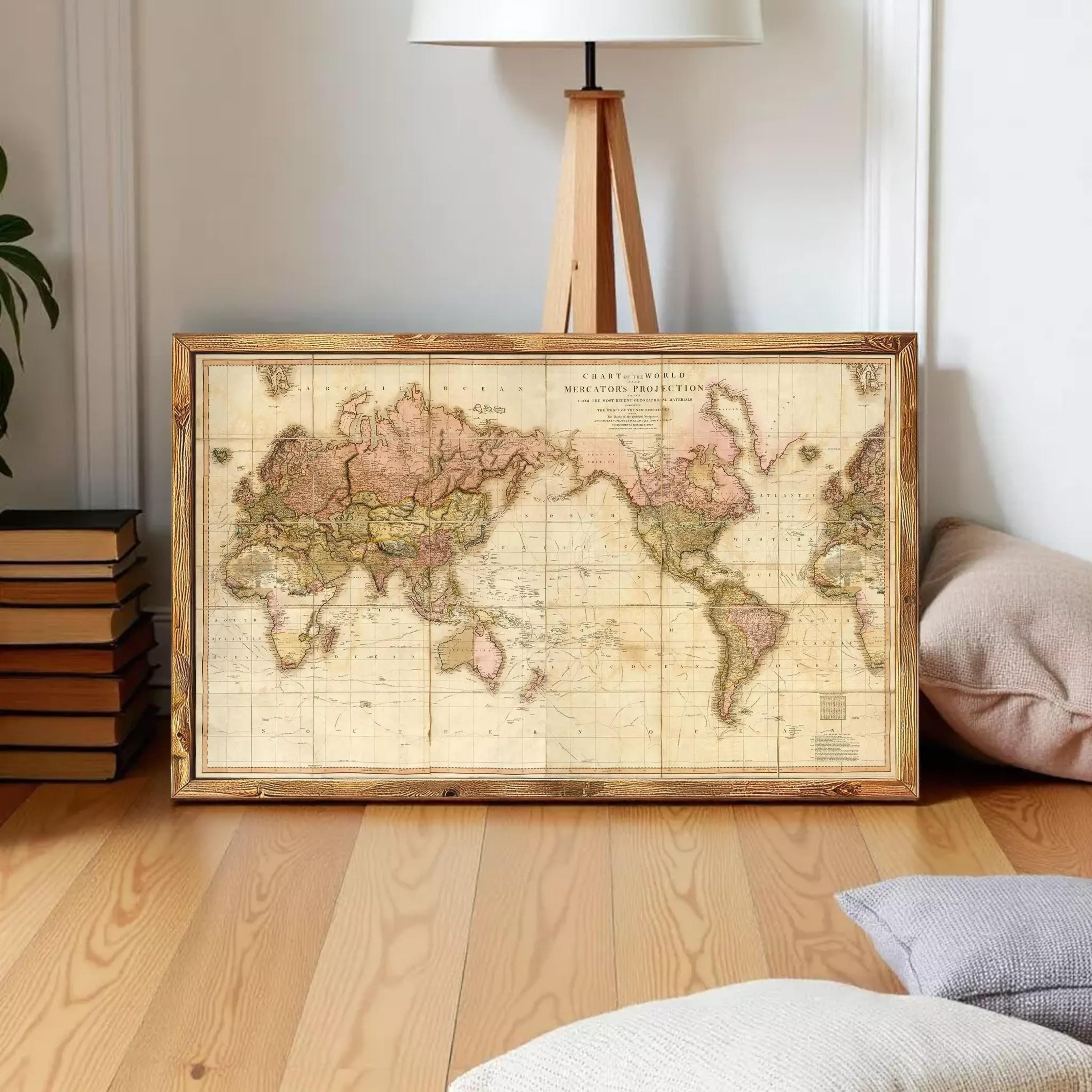 a vintage world map in a wooden frame, displayed on a white wall.