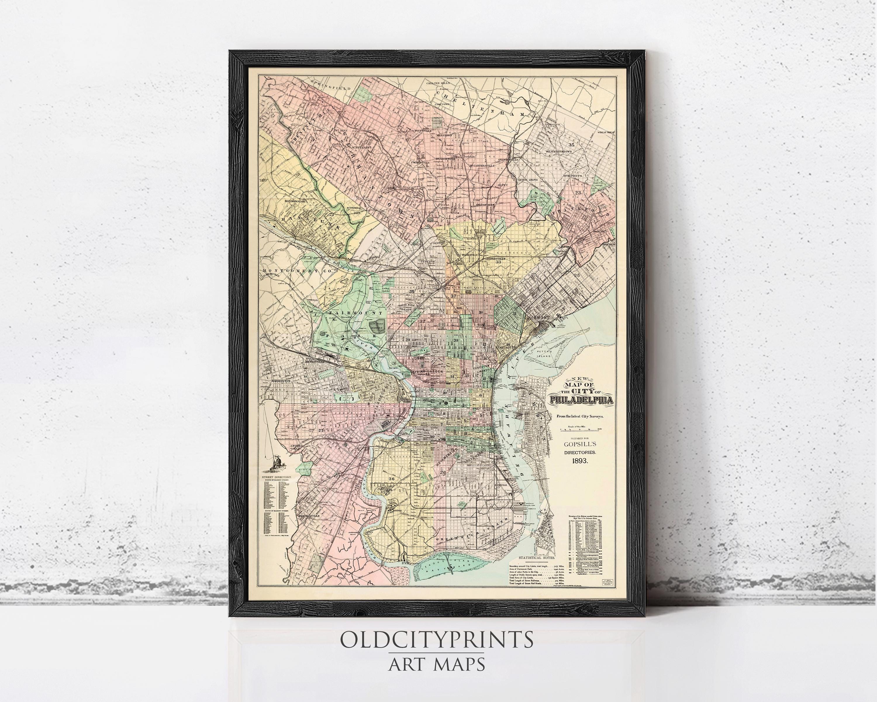 The image is a framed vintage map of Philadelphia, Pennsylvania, depicting the city's streets, neighborhoods, and surrounding areas.