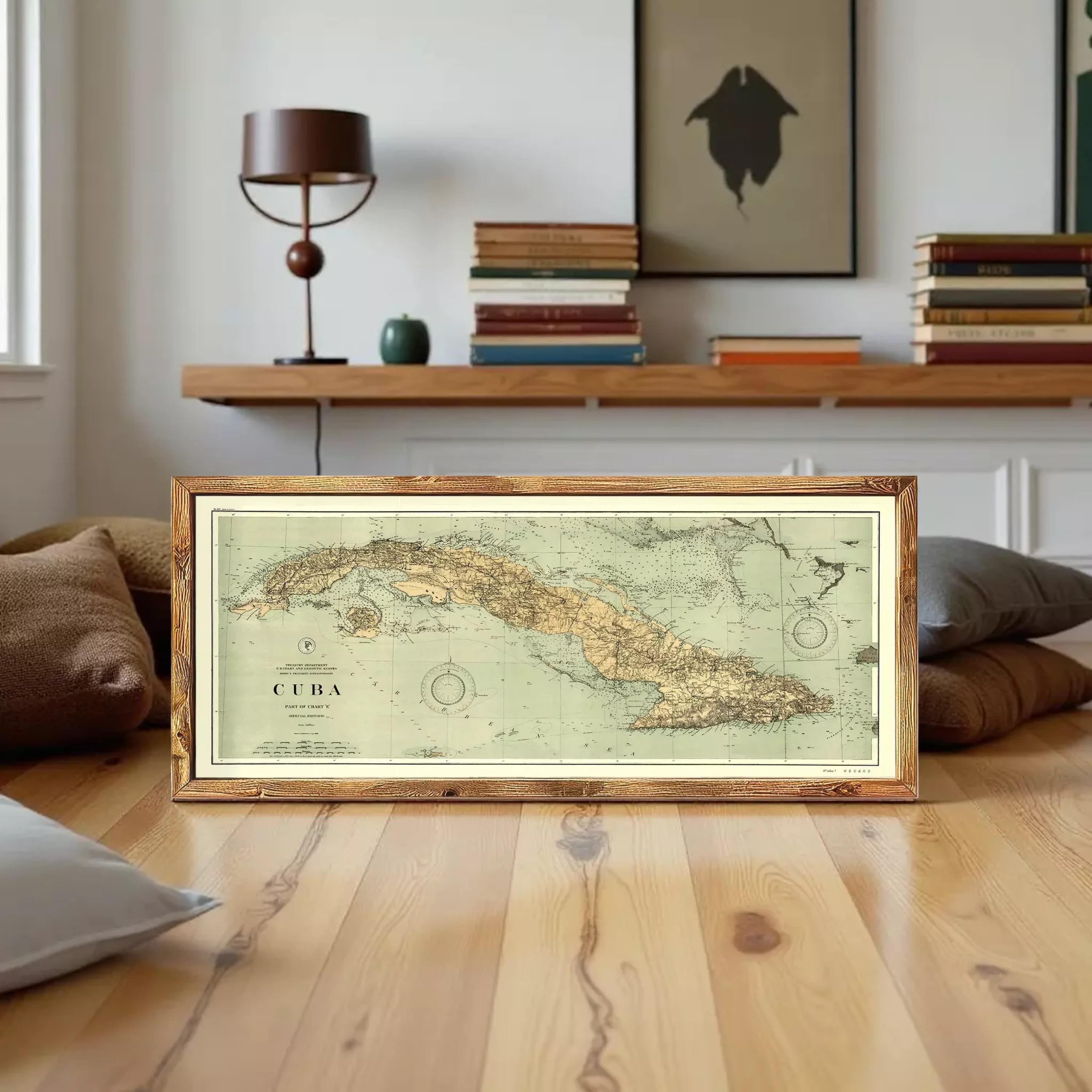 A framed vintage map of Cuba is displayed against a white wall.