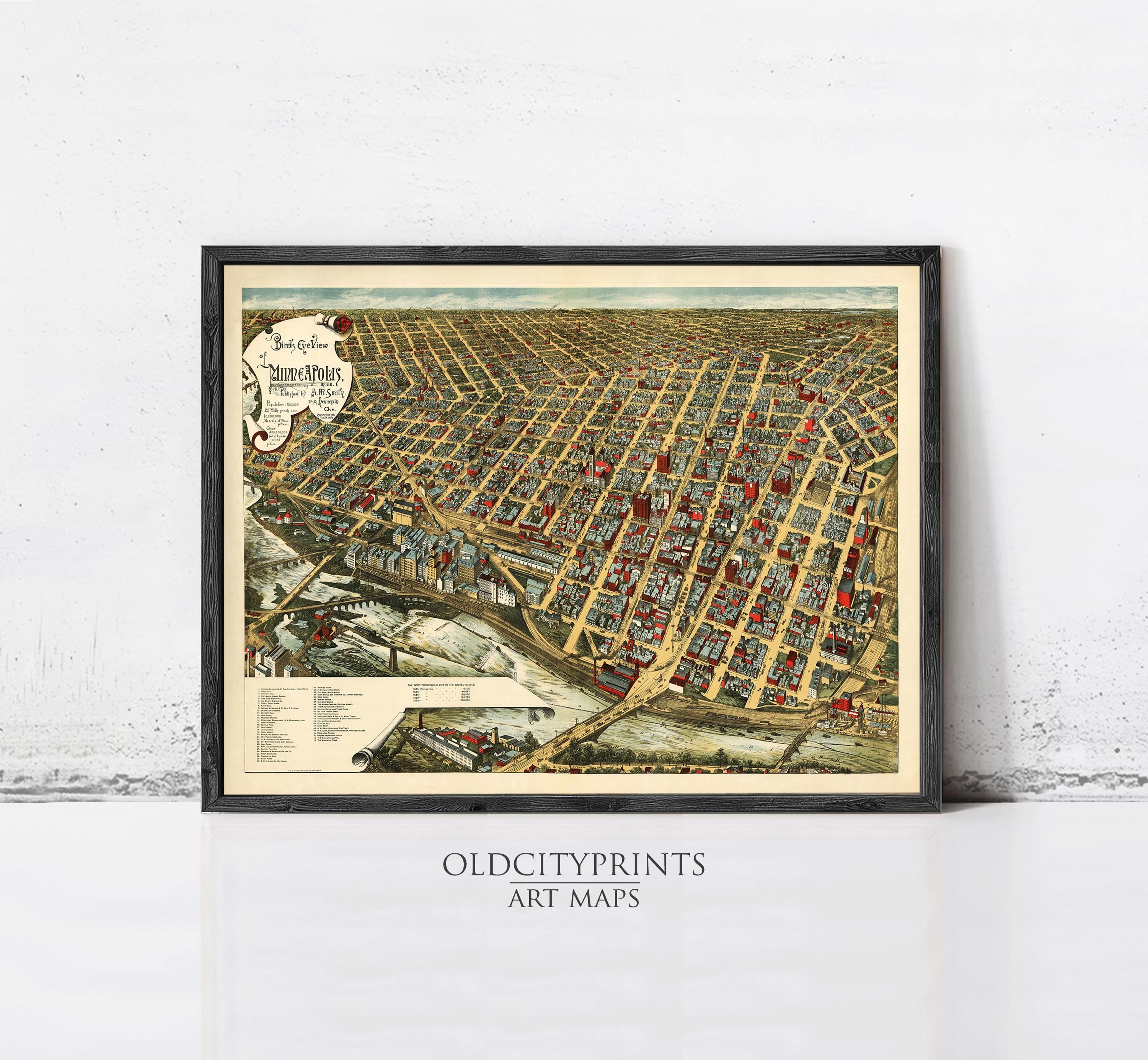 The image is a framed vintage map of a city, depicting a densely populated urban area with numerous buildings and streets.