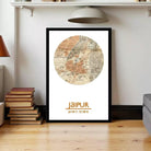A framed map of Jaipur, India, with the city's name prominently displayed. The map is surrounded by a border, and the image is set against a white wall.