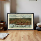 The image is a framed painting depicting a cityscape with boats and ships in the water, set against a cloudy sky.