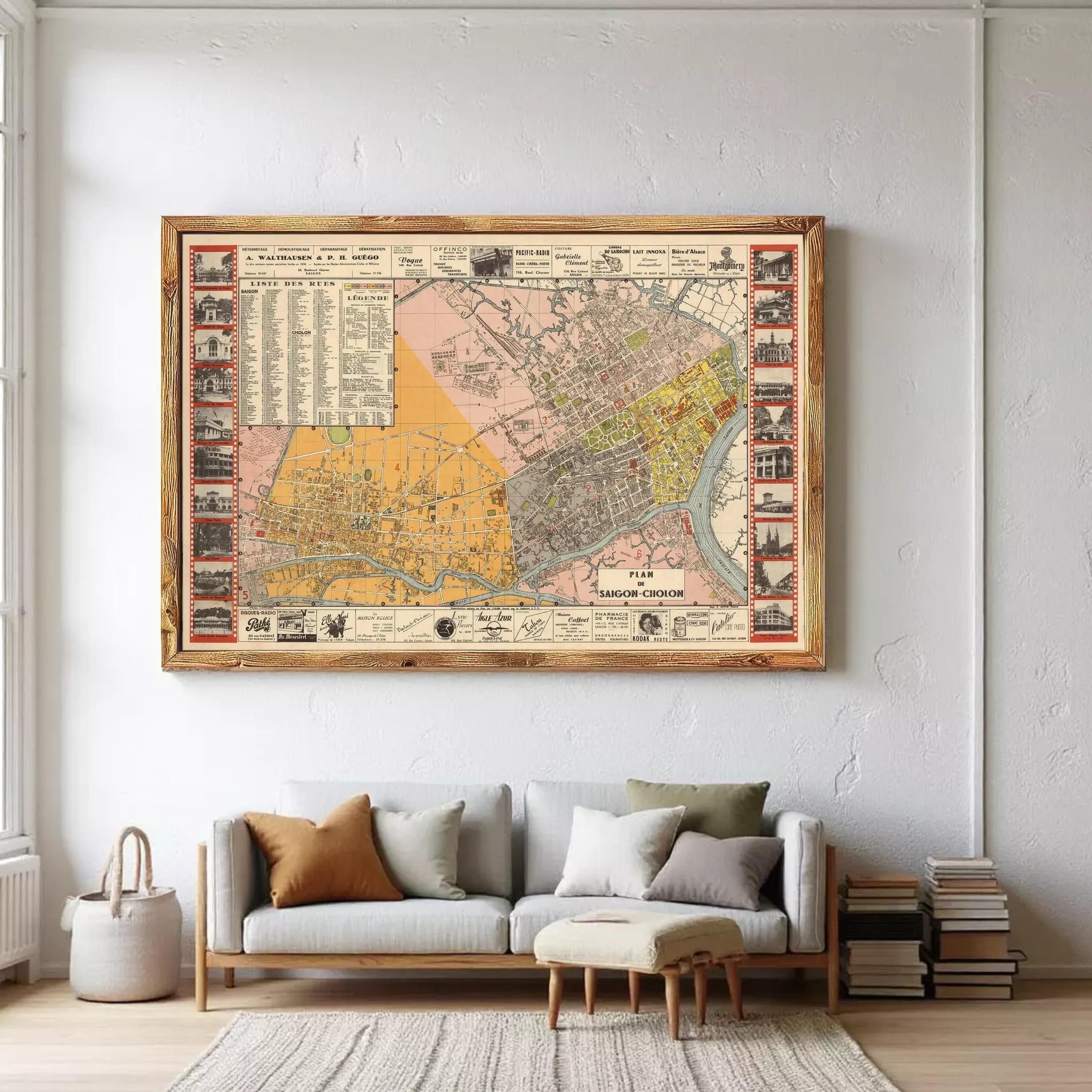 a large framed map of a city hanging on a wall above a couch in a living room.
