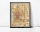 The image is a framed vintage map of a city, likely Paris, with various landmarks and streets depicted in a detailed and colorful manner.
