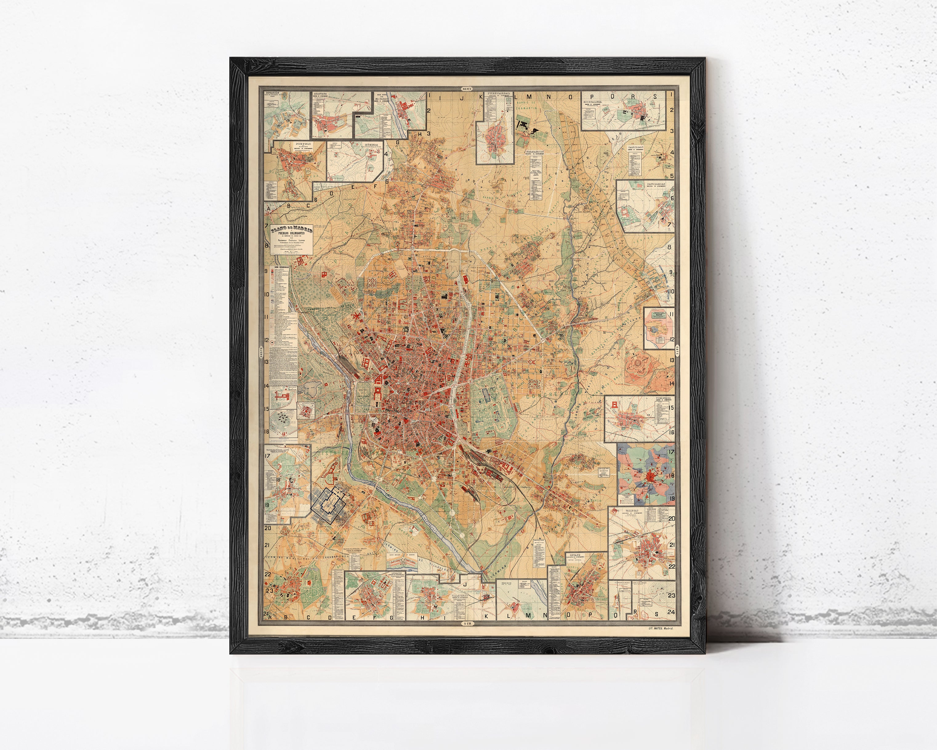 The image is a framed vintage map of a city, likely Paris, with various landmarks and streets depicted in a detailed and colorful manner.