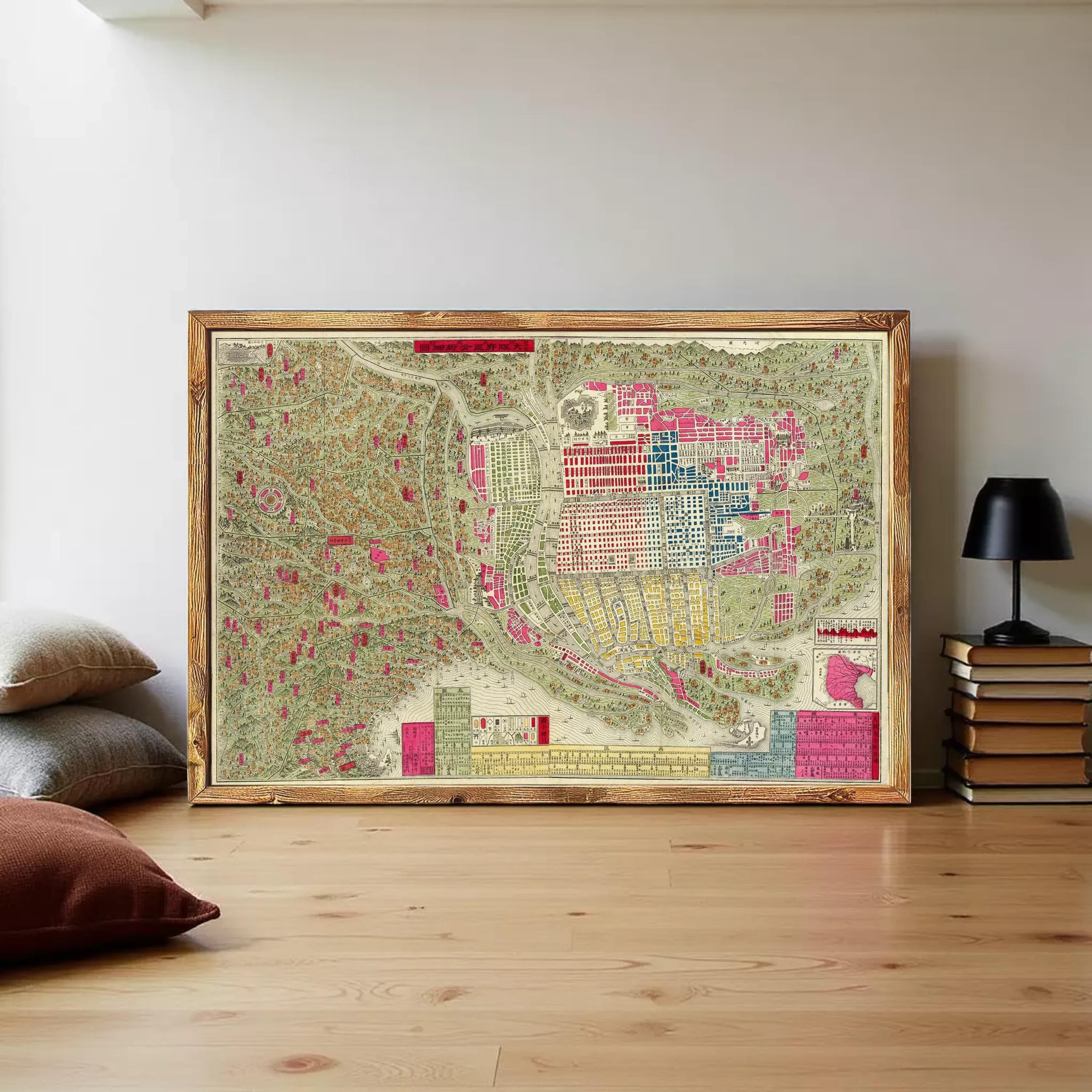 The image is a framed vintage map of a city, depicting various landmarks and streets in a colorful and detailed manner.